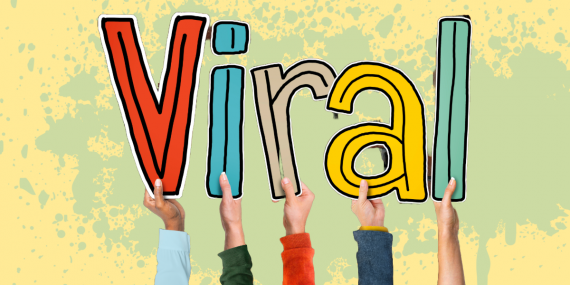 Five hands each holding up one letter spelling "viral" to illustrate viral content.