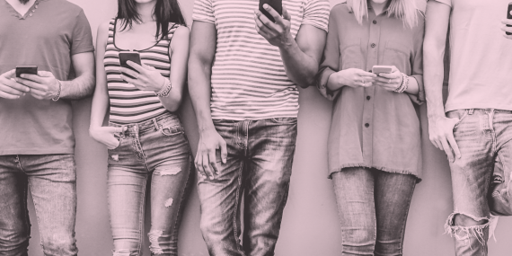 torsos of a line of people using their cellphones